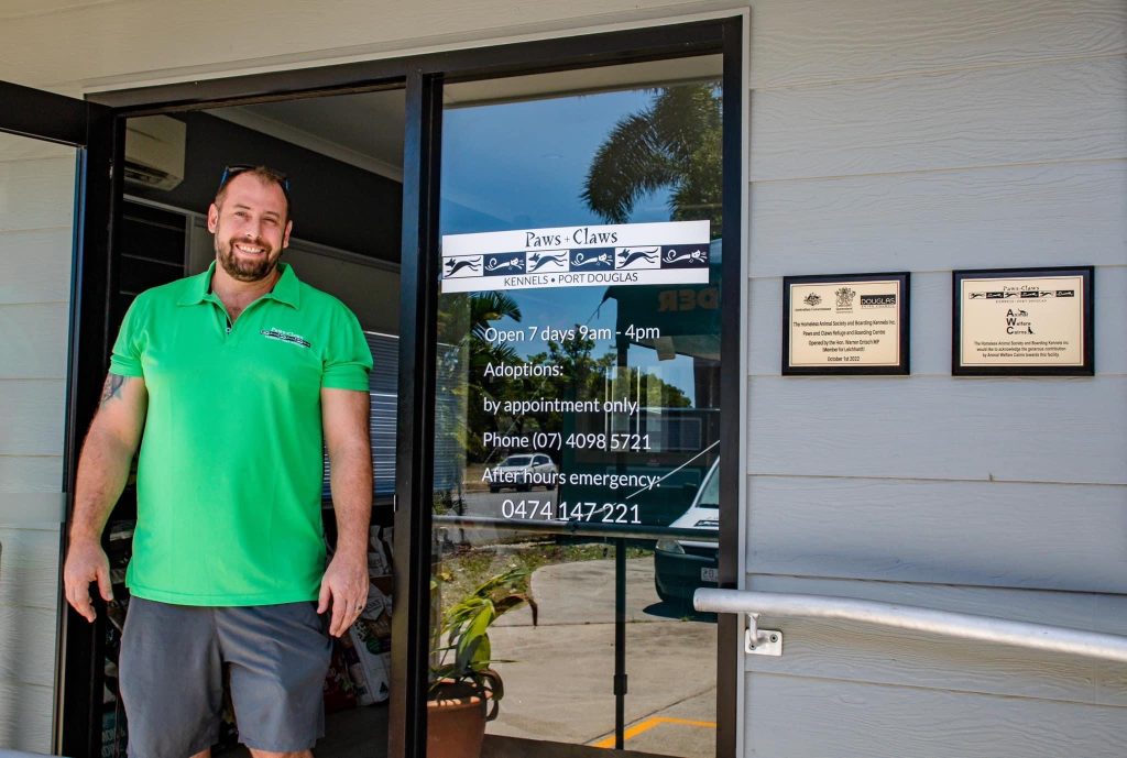 Paws and Claws team member at the shelter entrance